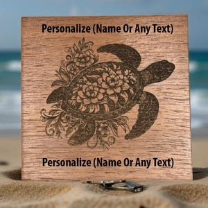 May include: A wooden square with a detailed engraving of a sea turtle surrounded by floral designs. The text "Personalize (Name Or Any Text)" is above and below the turtle. The wood has a natural grain and a warm brown color.