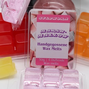 Op de afbeelding: Zes roze wax melts in een doorzichtige plastic verpakking met een label waarop staat "Sylphora Marshmallow Handgegossene Wax Melts 50g | 6 Duftende Wax melts".