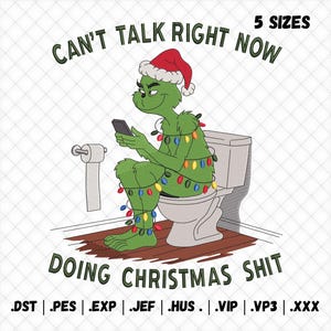 May include: An embroidery design featuring a green character wearing a red Santa hat, sitting on a toilet while holding a smartphone and wrapped in colorful Christmas lights. The text reads CAN'T TALK RIGHT NOW DOING CHRISTMAS SHIT with 5 SIZES.