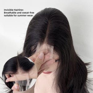 May include: A dark brown wig featuring an invisible hairline with a lace base. The text on the image reads: Invisible Hairline: Breathable and sweat-free suitable for summer wear. The wig has a straight texture and a central part.