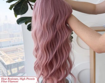 May include: A dusty rose wig with long, wavy hair. The wig is held up, showcasing its texture and color. Text on the image reads: Heat-Resistant, High-Protein Fiber Filament.