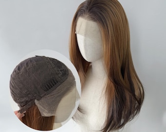 May include: A long, straight wig featuring a rooted brown and blonde color gradient with dark roots transitioning into lighter tones. The wig includes a sheer lace front section and an interior view showing the dark brown mesh cap construction.