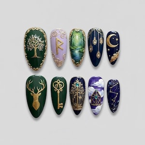 May include: A collection of ten almond-shaped nail designs. Each nail features intricate artwork, including a tree, a rune, a forest scene, lanterns, a crescent moon, a deer, a key, a gate, clouds, and a constellation, all in various colors.