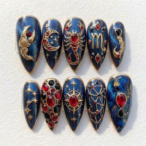 May include: A white ceramic mug with a black handle and the text "But First, Coffee" in a black, handwritten-style font. The mug is on a white surface.