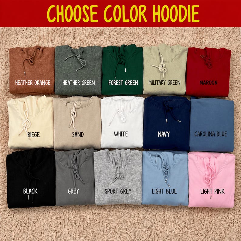 Pode incluir: Uma sele&ccedil;&atilde;o de hoodies em v&aacute;rias cores, incluindo laranja mesclado, verde floresta e rosa claro. Cada hoodie &eacute; exibido dobrado, com o nome da cor impresso abaixo. O texto "CHOOSE COLOR HOODIE" est&aacute; no topo.