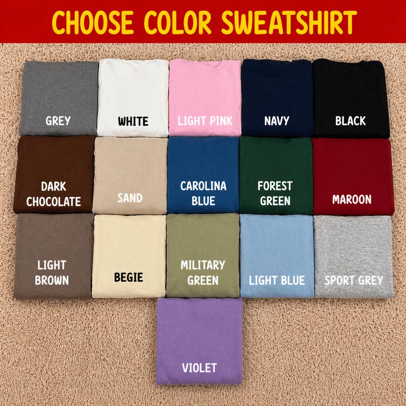 Pode incluir: Uma sele&ccedil;&atilde;o de camisolas dobradas em v&aacute;rias cores, incluindo cinzento, branco, rosa, azul marinho e preto. Cores adicionais s&atilde;o chocolate escuro, areia, azul Carolina, verde floresta, bord&ocirc;, castanho claro, bege, verde militar, azul claro, cinza desportivo e violeta. O texto no topo diz "CHOOSE COLOR SWEATSHIRT."
