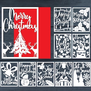 May include: A collection of white paper cutouts with Christmas-themed designs. The designs include text like "Merry Christmas", "Merry & Bright", and "Joy to the World", along with images of a Christmas tree, reindeer, and snowflakes. The background is red and dark blue.