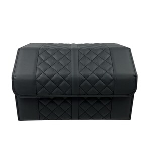 May include: Black, quilted storage container with a rectangular shape. The container features a diamond pattern on the top and front panels, with a solid black finish. The lid folds over the front, and the container is designed for storage.