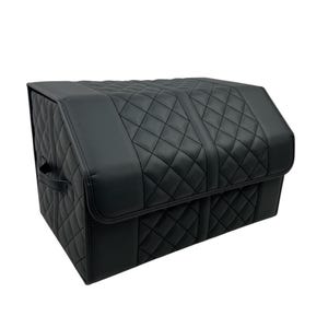 May include: A black, quilted, rectangular storage container with a hinged lid. The container features a diamond pattern and a handle on the side. The material appears to be leather or a leather-like material.