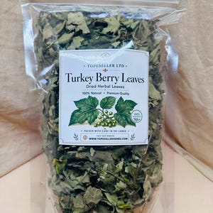 May include: A clear plastic resealable pouch filled with dried green Turkey Berry leaves. The white label features the text Topeseller Ltd, Turkey Berry Leaves, Dried Herbal Leaves, 100% Natural, Premium Quality, and www.topesellerherbs.com.
