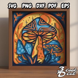 May include: A framed paper art piece with a mushroom design. The artwork uses layers of orange, blue, and yellow paper. The text "SVG PNG DXF PDF EPS" is at the top, and "3 cool cut" is at the bottom. The frame is made of wood.