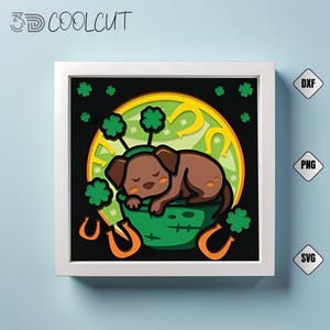May include: A layered paper art piece featuring a sleeping brown dog wearing a green headband with shamrocks, resting in a green pot. The background includes a yellow circle with horseshoes and shamrocks, all within a white frame. The text "3D COOLCUT" is at the top.