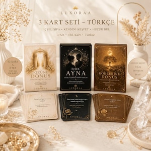 May include: A set of three card decks with Turkish text, including "3 KART SETİ - TÜRKÇE". The decks are in beige, black, and gold tones, with illustrations and text. The set includes 156 cards total.