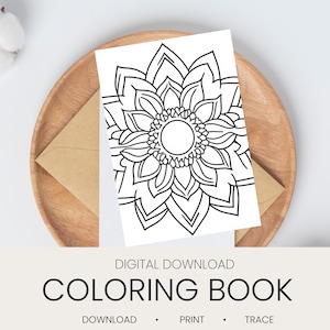 Può includere: Una pagina di libro da colorare in bianco e nero con un elaborato motivo floreale a mandala. La pagina è su sfondo bianco, appoggiata su un piatto di legno con una busta marrone. Il testo "COLORING BOOK" è visualizzato sotto, con "DOWNLOAD • PRINT • TRACE".