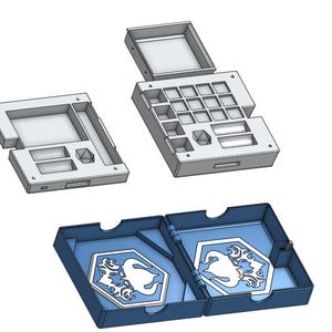 May include: A collection of 3D-printed storage boxes. Two gray boxes are open, revealing compartments. A blue box with a hinged lid is open, displaying two white and blue emblem designs. The boxes are designed for organizing small items.