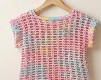 May include: A short-sleeved crochet top featuring an open-knit grid pattern. The yarn is dyed in a variegated color palette of soft pastel pink, light blue, and pale yellow, creating a blended, multi-colored effect throughout the garment.