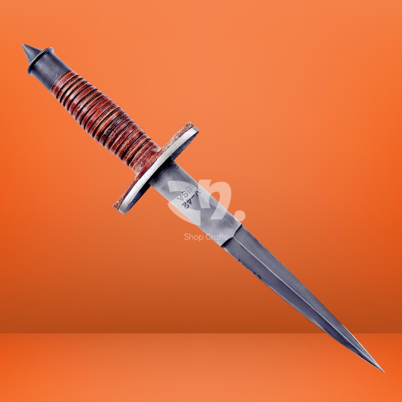 May include: A double-edged stiletto knife featuring a brown leather-wrapped handle with a series of horizontal ridges, a metal pommel, a crossguard, and a steel blade stamped with the text V-42 USA near the hilt, presented against an orange background.