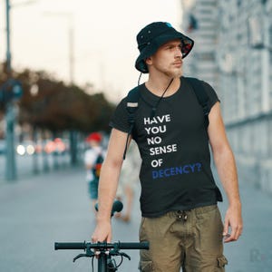 a man with a hat and a bicycle on a city street