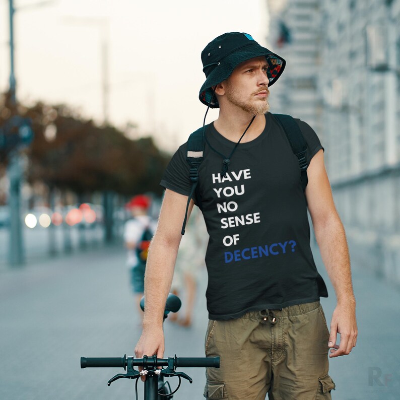 a man with a hat and a bicycle on a city street