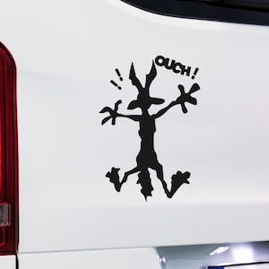 May include: Black and white silhouette of a cartoon coyote with the word "OUCH!" above it. The coyote is in a running pose with its arms outstretched.