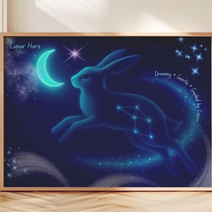 May include: A framed art print featuring a blue hare leaping across a starry night sky. The artwork includes a glowing crescent moon, a constellation, and the text "Lunar Hare". Additional text reads "Dreamy, Gentle, Guided by Lepus".