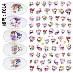 May include: Nail art decals with skull designs decorated with colourful floral arrangements. The decals include various skull illustrations with flowers in shades of red, pink, purple, and yellow. The text "F614" is visible.