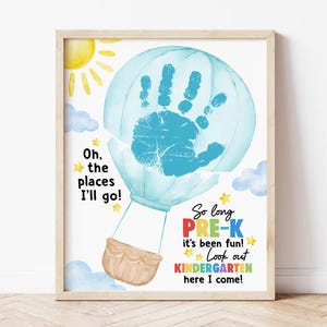 May include: A framed watercolor print featuring a blue hot air balloon with a handprint inside. Text includes "Oh, the places I'll go!" and "So long PRE-K, Look out KINDERGARTEN here I come!" with a sun and clouds.