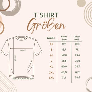 May include: A size chart for t-shirts with measurements in centimeters. The chart shows the size, width, and length of each size from XS to 3XL. The chart is on a white background with brown and beige abstract shapes.