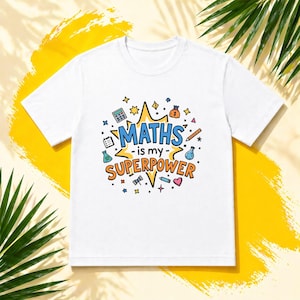 May include: White t-shirt featuring the phrase "MATHS is my SUPERPOWER" in a vibrant design. The graphic includes a calculator, money bag, and other math-related icons. The shirt is made of a soft, comfortable material.