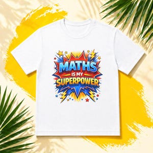 May include: White t-shirt featuring the text "MATHS IS MY SUPERPOWER" in a vibrant, comic-book style design. The graphic uses blue, red, and yellow colours, with star and lightning bolt details. A fun, educational tee.