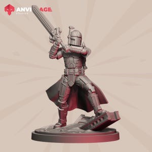 May include: A grey Mandalorian action figure with a large sword, standing on a circular base. The figure is wearing detailed armour and a helmet. The Anvitage Studios logo is visible in the upper left corner.
