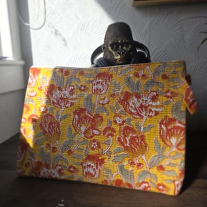 May include: A white ceramic mug with a black handle and the text "But First, Coffee" in a bold, black font. The mug is displayed on a white surface, showcasing its clean design.