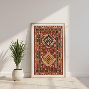 May include: Framed print of a patterned rug in a wooden frame. The rug features a central diamond design in navy, yellow, and white on a red background. The border includes geometric shapes in orange, navy, and yellow. The print is displayed against a white wall.