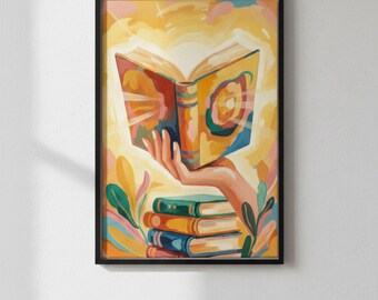 Könnte beinhalten: Gerahmter Kunstdruck mit einer farbenfrohen Illustration einer Hand, die ein offenes Buch hält, mit Licht, das von den Seiten ausgeht. Darunter ein Stapel Bücher in verschiedenen Farben. Das Kunstwerk hat eine warme Farbpalette.