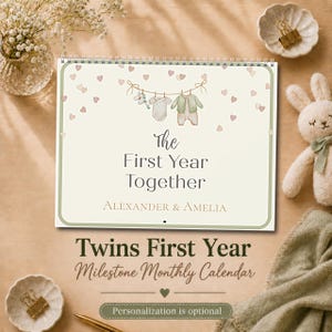 Puede incluir: Un calendario de espiral titulado The First Year Together con los nombres Alexander & Amelia. La portada presenta una ilustración en acuarela de ropa de bebé en un tendedero rodeada de pequeños corazones sobre un fondo crema claro.