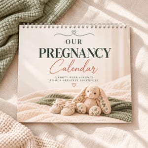 May include: A spiral-bound pregnancy calendar with a cream-colored cover featuring the text OUR PREGNANCY Calendar A FORTY-WEEK JOURNEY TO OUR GREATEST ADVENTURE. The cover displays a beige knitted bunny toy and matching baby booties.