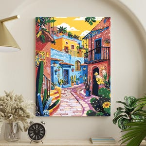 May include: A colourful painting showcases a street scene with buildings in blue, yellow, and red. Cacti and potted plants line the cobbled path. The artwork creates a warm, sunny atmosphere, ideal for home decor.