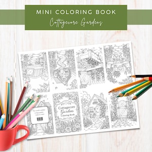 Könnte beinhalten: Ein Mini-Malbuch mit dem Titel Cottagecore Gardens mit acht schwarz-weißen Strichzeichnungen von Gartenszenen. Ein roter Becher mit Buntstiften steht links, während mehrere lose Buntstifte auf der Seite des Malbuchs liegen.