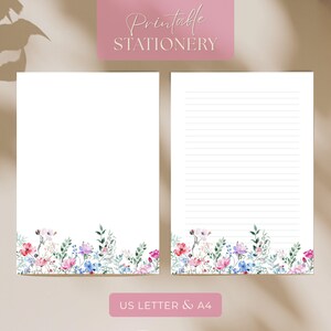 May include: A printable stationery set with a blank page and a lined page. Both pages have a floral border with pink, blue, and white flowers and green leaves. The text "Printable Stationery" is at the top, and "US Letter & A4" is at the bottom.
