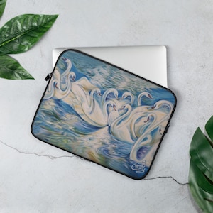 May include: A laptop sleeve with a colorful painting of white swans swimming in blue water. The painting is a vibrant and detailed depiction of the swans, with their feathers and the water reflecting light.