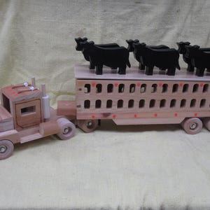 Semi and cattle pot with 6 black steers.