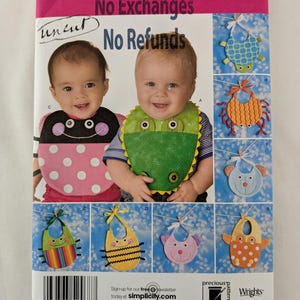 May include: Simplicity sewing pattern number 2468 for making baby bibs. The pattern includes instructions for making eight different bibs with various animal designs, including a turtle, crab, bear, frog, bee, cat, and owl. The pattern is for one size and is uncut. The pattern also includes the text "No Exchanges" and "No Refunds".