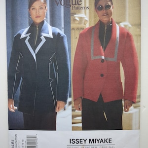 May include: A Vogue Patterns sewing pattern envelope for an Issey Miyake designer original, number 1481. The cover displays two jacket variations: a dark blue jacket with white trim and a red jacket with grey trim, both featuring a front zipper closure.
