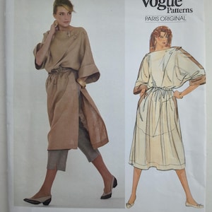 May include: A Vogue Patterns sewing pattern envelope for a Claude Montana design, number 2973. The cover features a photograph and an illustration of a long, loose-fitting tunic with wide sleeves and a drawstring waist, paired with cropped trousers.
