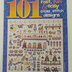 May include: A book cover with a blue background and the title "101 fast, fun & easy cross stitch designs". The cover features a variety of colorful cross stitch designs, including stars, stripes, and a train.