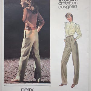 May include: A Vogue American Designers sewing pattern envelope for Perry Ellis design 2677. The cover features a photograph and an illustration of a long-sleeved button-up shirt with a high collar and high-waisted trousers with a belt.