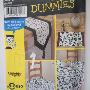 May include: Simplicity sewing pattern for table coordinates, featuring designs for table runners, placemats, and a tablecloth. The pattern includes the text "Sewing Patterns for Dummies" and "Stitch up a storm the Fun and Easy Way".