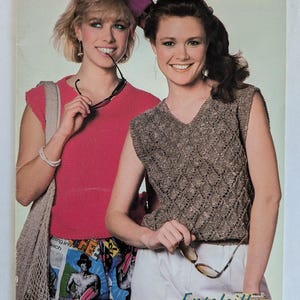 May include: A magazine cover featuring two women wearing knitted tops. The magazine is titled "Beehive Sunshine Knits" and the cover text reads "Ensoleillez Vos Tricots".