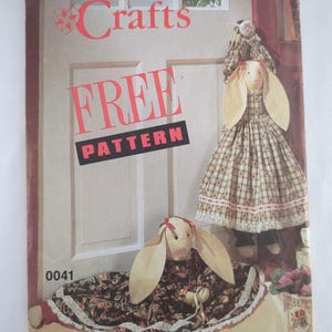 May include: A vintage Simplicity Crafts pattern cover with the words "FREE PATTERN" in large red letters. The cover features a handmade bunny doll with long ears and a patterned dress. The number "0041" is visible.