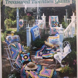 May include: A book titled Treasured Twenties Quilts by Silver Threads with Sharon Newman. The cover features a collection of colorful patchwork quilts and pillows displayed on white metal chairs and a brick patio in a garden setting.